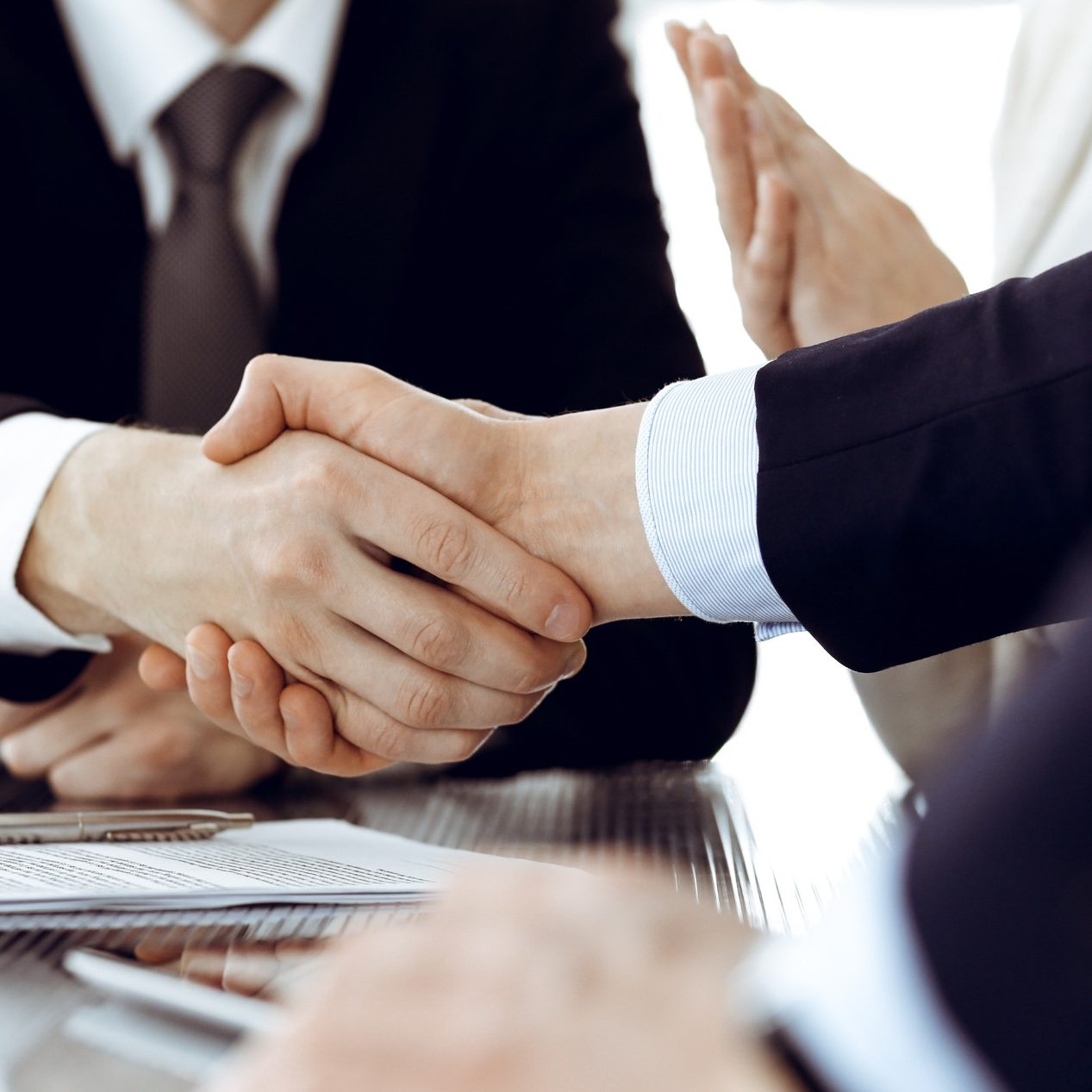 Handshake to represent conflict resolution as a result of mediation in the workplace